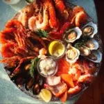 Delicious Christmas seafood platter with shrimp, crab, and lobster.