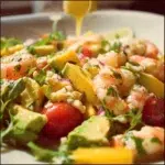 Delicious Prawn Mango Avocado Salad served in a bowl with fresh ingredients.
