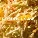 Bowl of addictive pineapple coleslaw with fresh ingredients and vibrant colors.