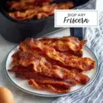 Crispy air fryer bacon served on a plate with a side of eggs