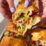 Chopped Italian Sliders topped with fresh herbs and served on a wooden board