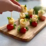 Emmental and prosciutto flower bites arranged on a serving platter