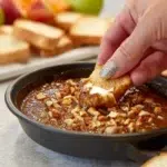 Delicious no-bake pecan pie dip served in a bowl with pecan topping.