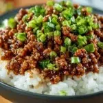 Delicious honey garlic turkey dish served with vegetables and rice.