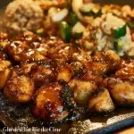 Blackstone Hibachi Chicken sizzling on a grill with fresh vegetables