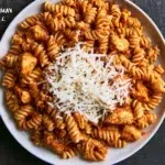 Healthy Garlic Parmesan Chicken Pasta dish with herbs and vegetables