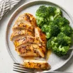Juicy baked chicken breast cooked in 30 minutes, served on a plate.