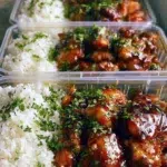 Sticky lemon pepper chicken garnished with lemon slices and spices